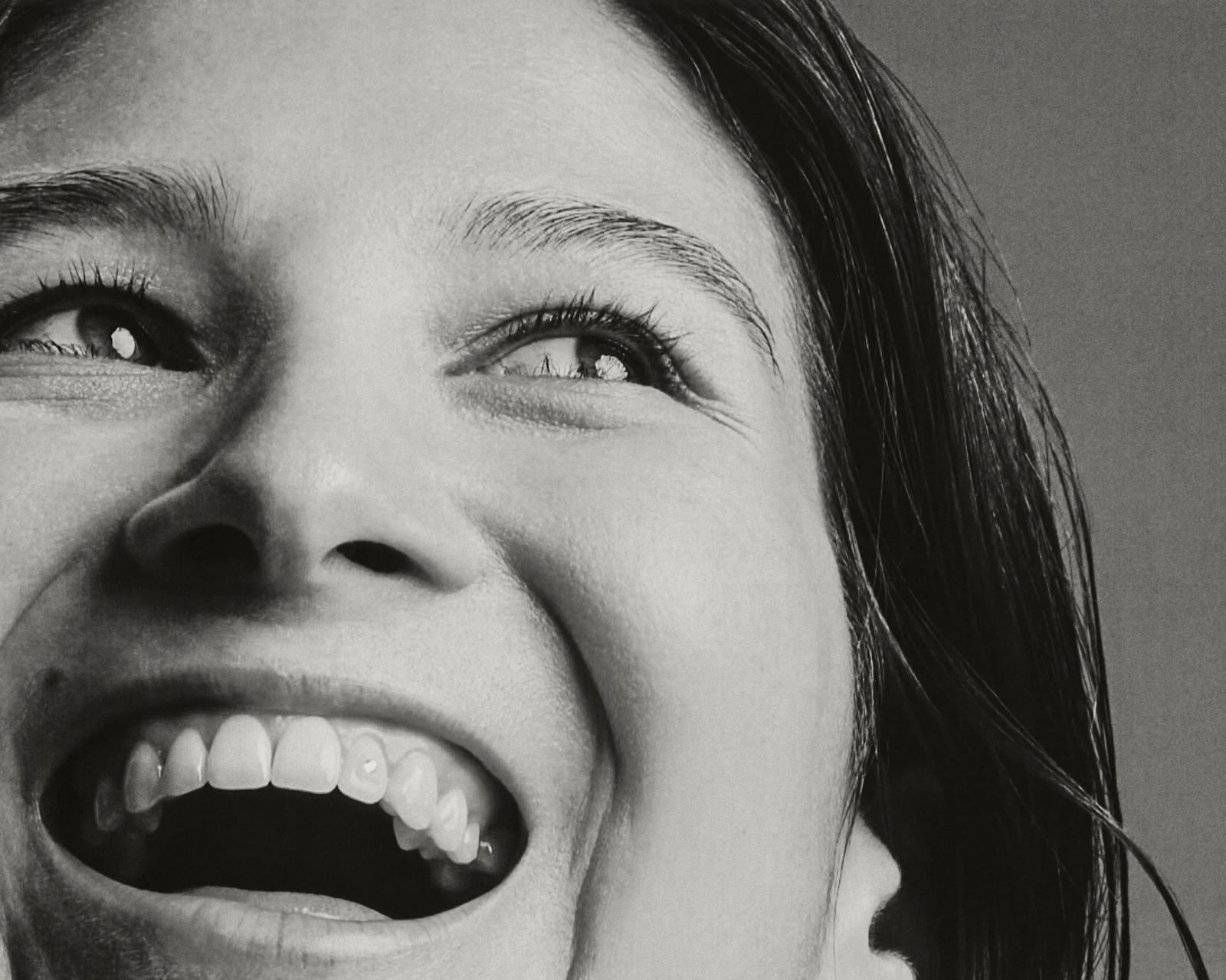 A woman in black and white smiling.